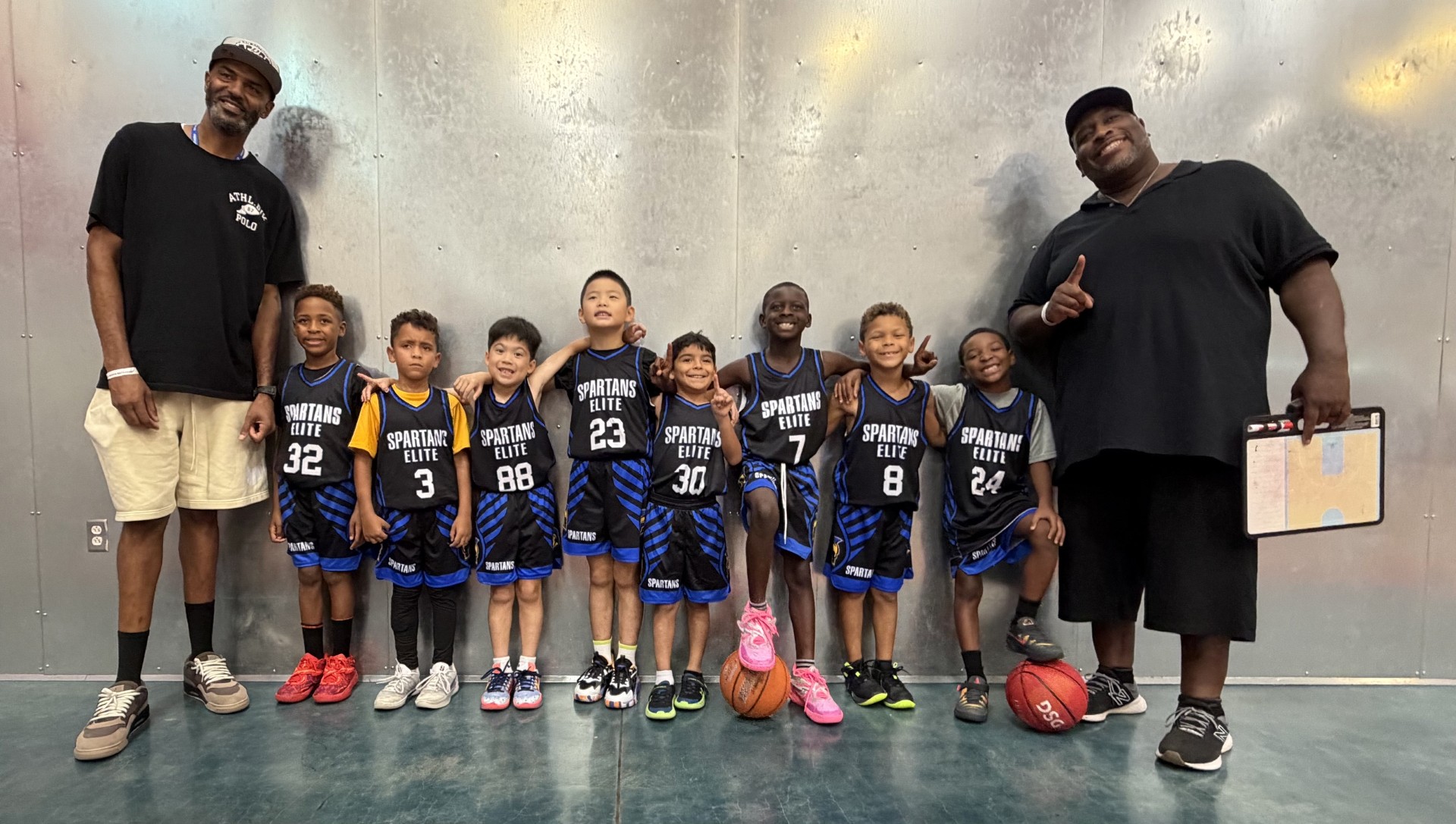 Spartans Elite players and their coaches standing together for a team photo