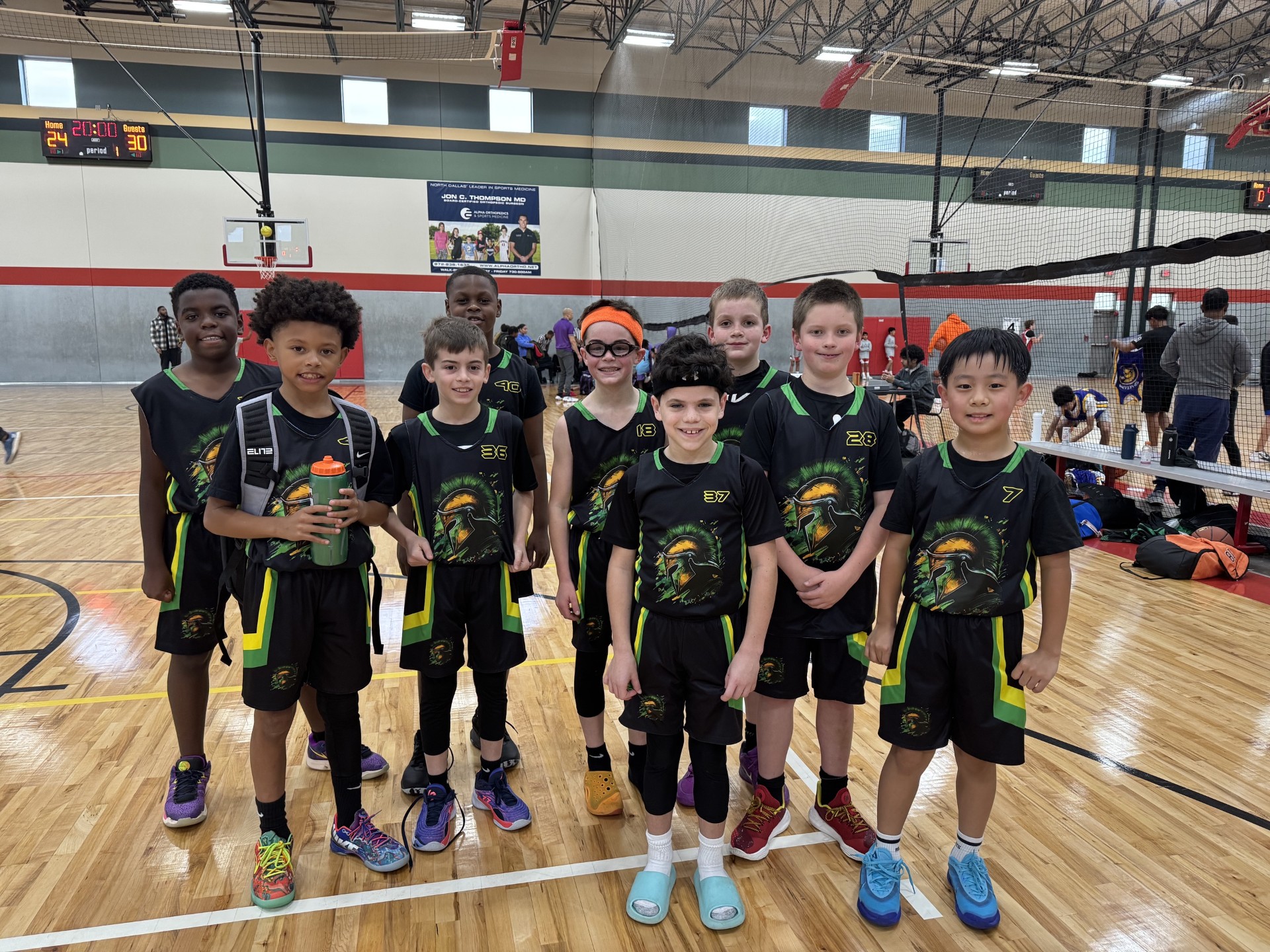 Spartan basketball players together in black and green team jerseys